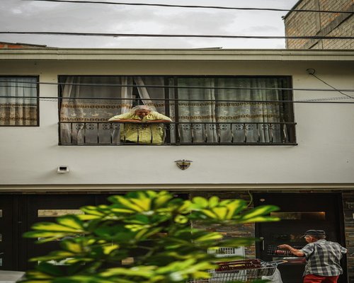Person doing light stretching by a window in a modern Colombian apartment